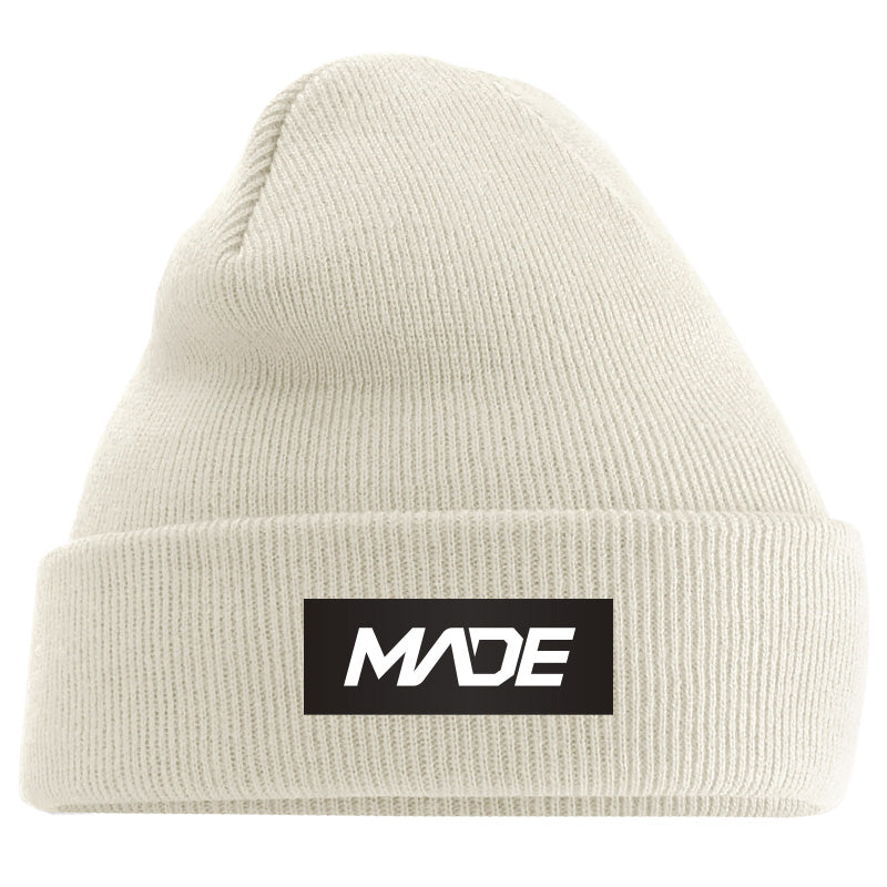 Beige beanie with 'MADE' logo on a black background - Madestickers.com Almond#color_almond